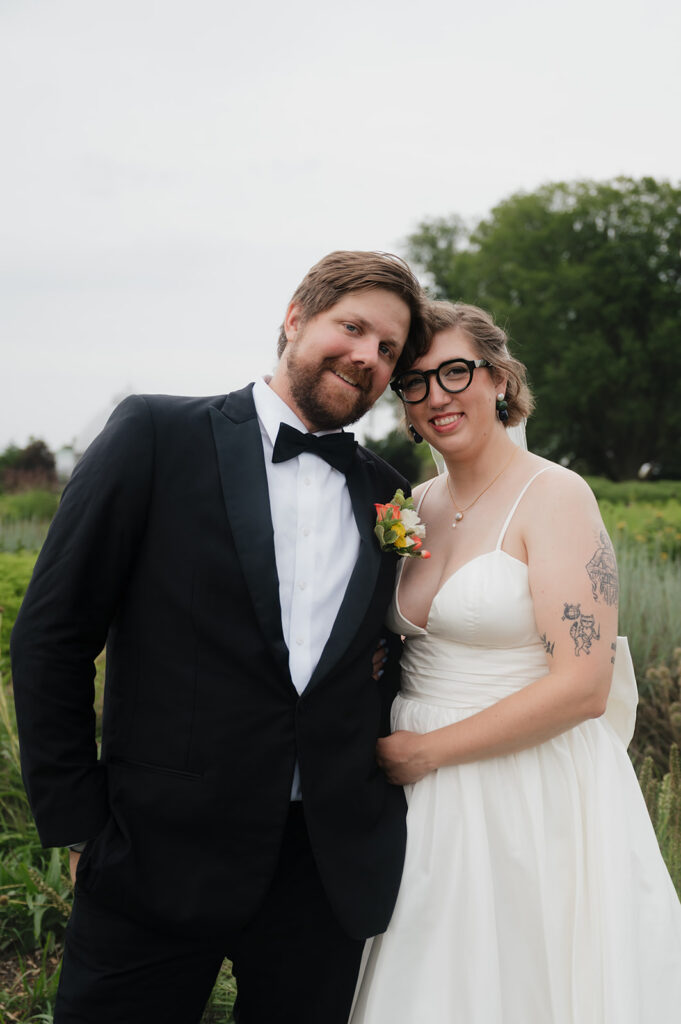 Bride and groom posing outdoors at Oudolf Garden in Detroit, Michigan.