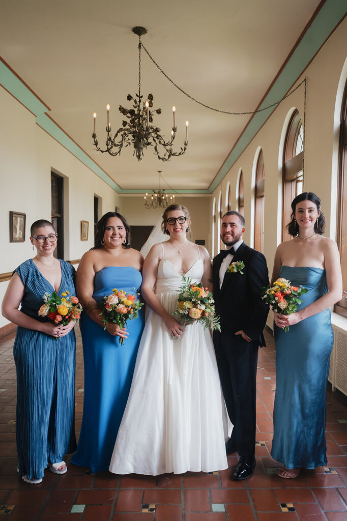 Bride and bridesmaids posing indoors for a Detroit Yacht Club wedding.