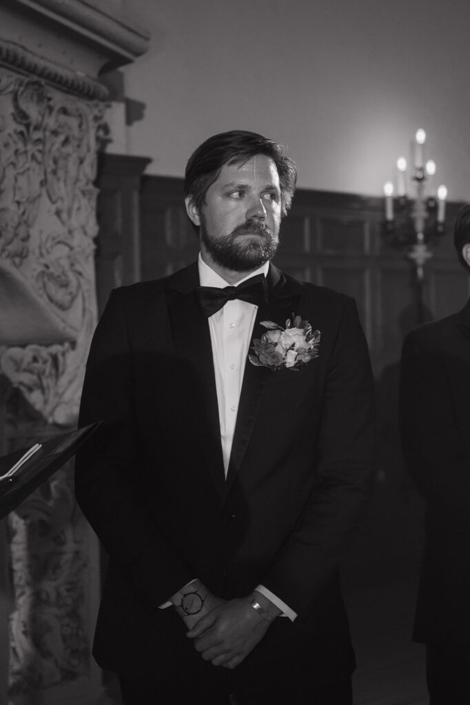 Groom standing at the altar during Detroit Yacht Club wedding ceremony.