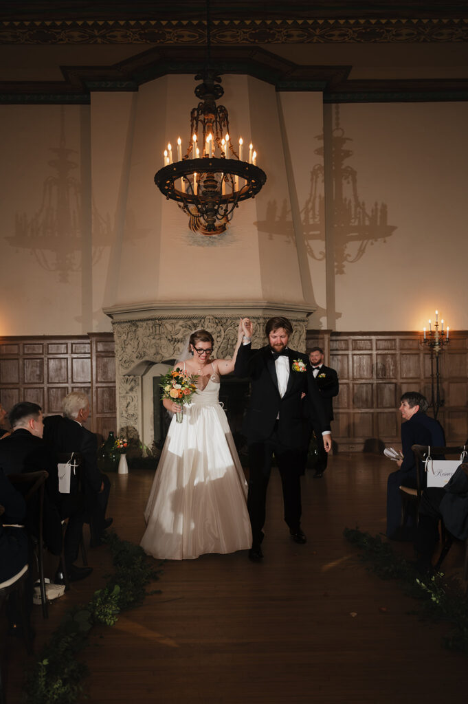 Bride and groom walking back down the aisle after ceremony at Detroit Yacht Club wedding as husband and wife.