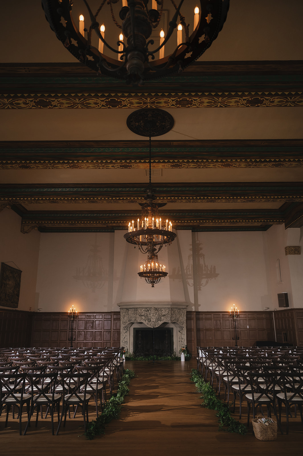 Ceremony setup inside Detroit Yacht Club with minimal decor and chandeliers.