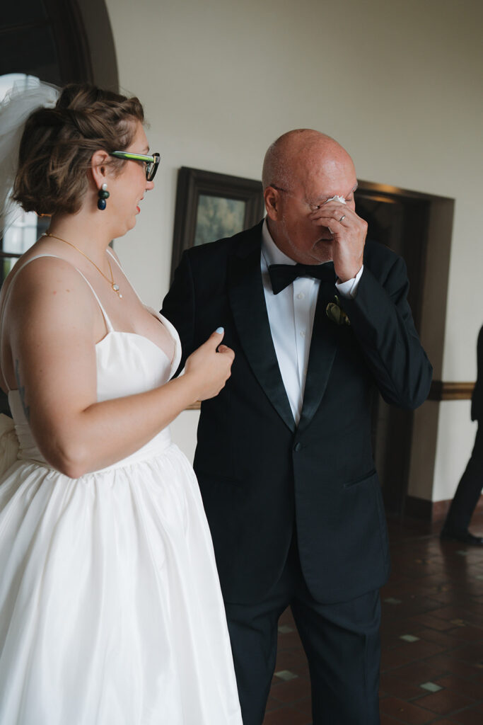Father getting emotional seeing his daughter during their first look.