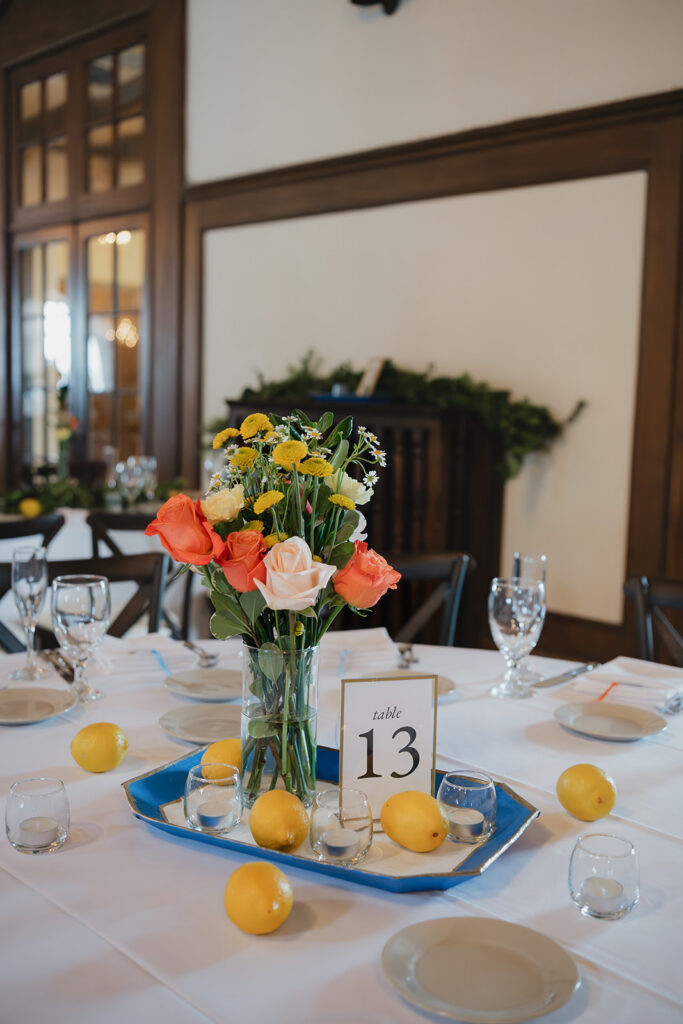 Detroit Yacht Club wedding reception table decorated with colorful florals and lemons.