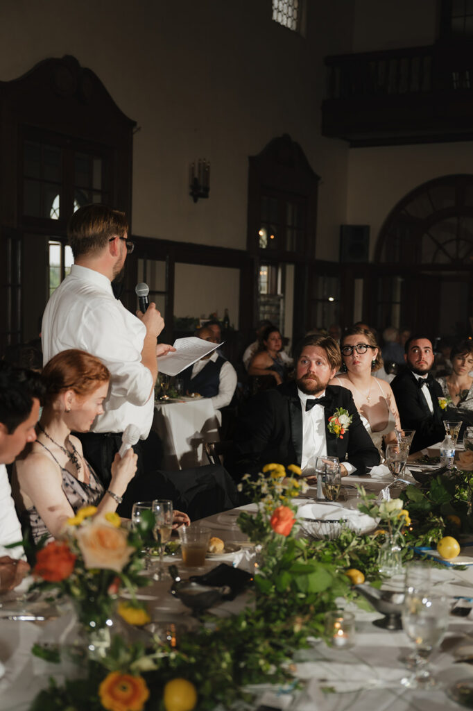 Guest giving a speech during a Detroit Yacht Club wedding reception.