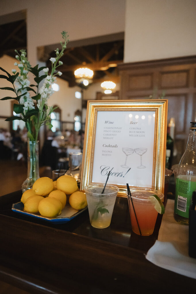 Bar menu with lemons, florals, and drinks.