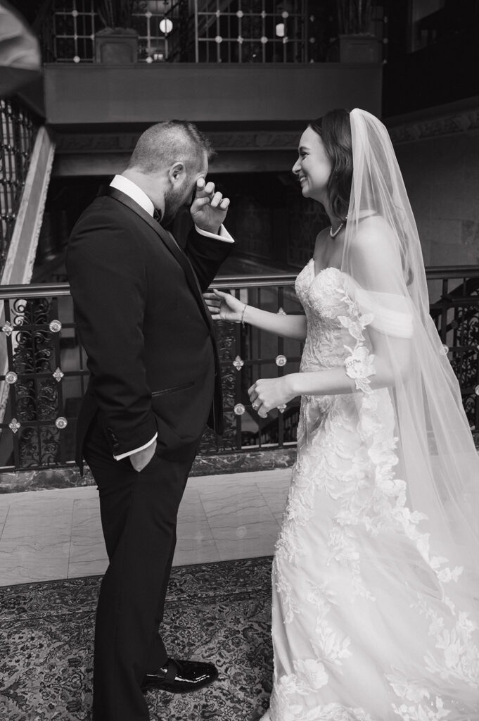 Bride and groom reacting during emotional first look at Element by Westin Detroit.