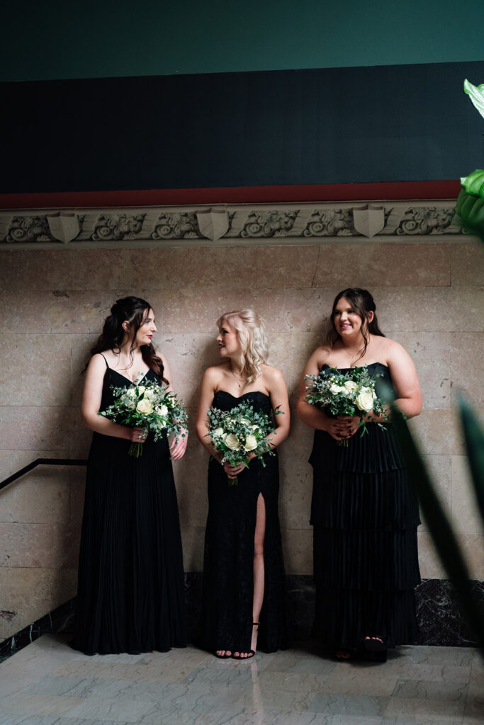 Candid photo of three bridesmaids talking.