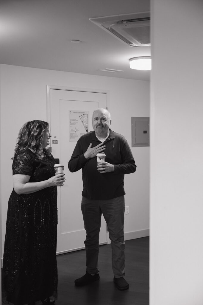 Black and white portrait of the brides mother and father getting emotional seeing their daughter get ready.