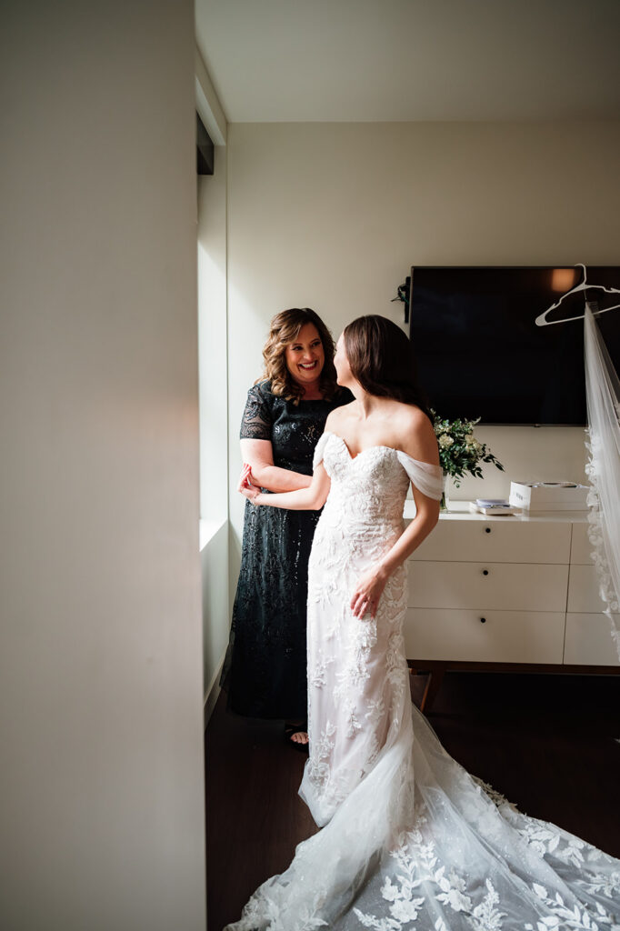 Bride smiling with her mom while getting ready at Element by Westin Detroit.