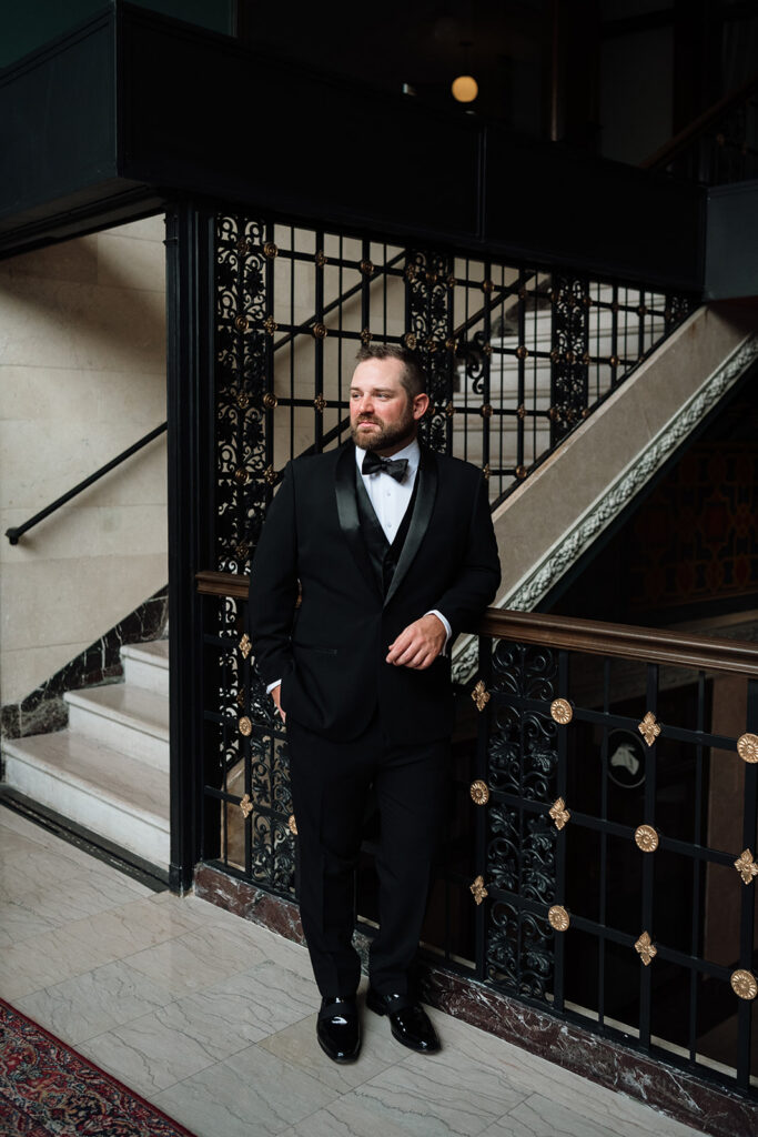Groom standing in suit during getting ready at Element by Westin Detroit.