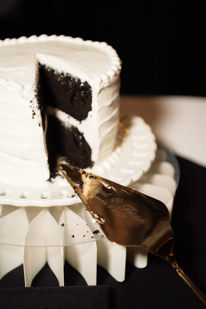 Close up shot of a cut into wedding cake.