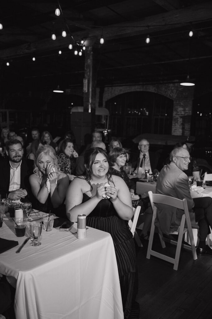 Guests reacting emotionally during reception speeches at Ford Piquette Avenue Plant.
