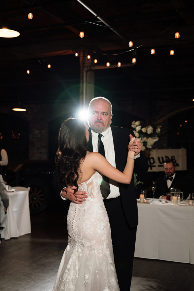 Bride dancing with her father while he gets emotional.