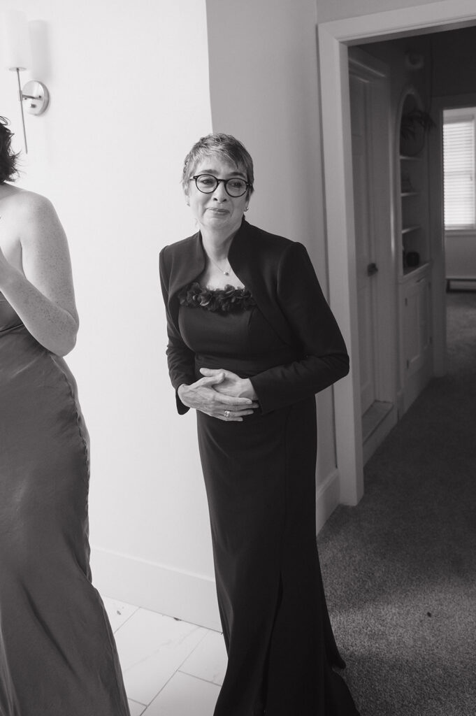 Black and white photo of the mother of the bride getting emotional.