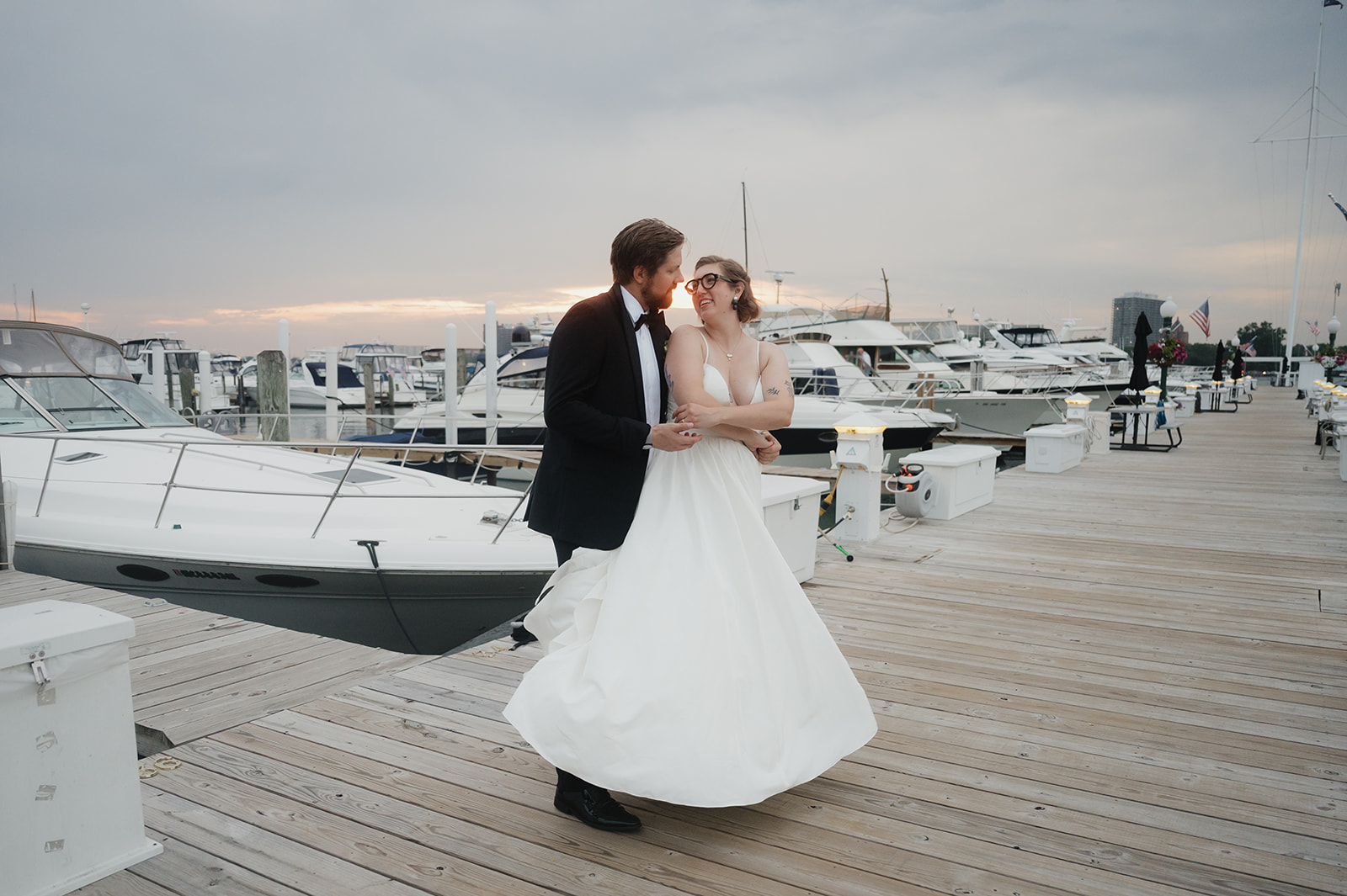 Bride and groom posing on the dock at Detroit Yacht Club at sunset.