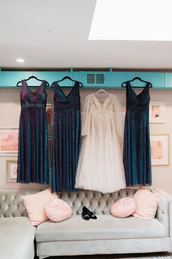 Bride and bridesmaids dresses hanging together before a Ferndale Michigan wedding.