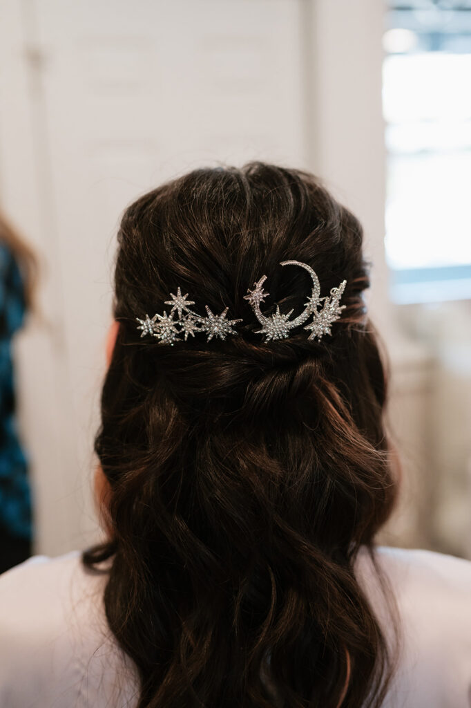 Bride wearing a celestial hairpiece while getting ready for her Ferndale Michigan wedding.