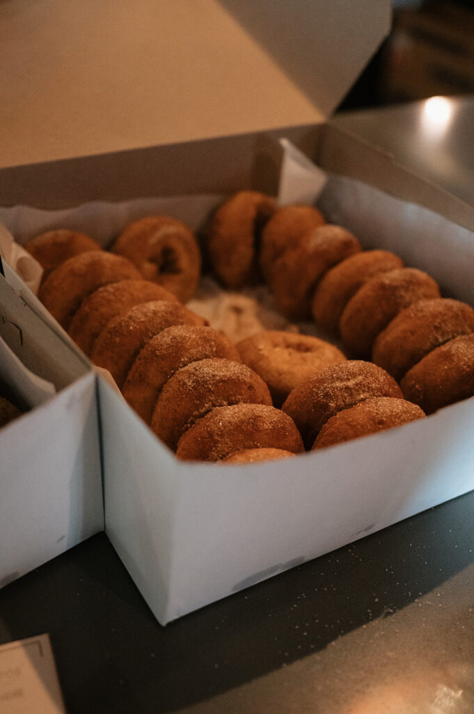 Box of donuts served during a Dog and Pony Show Brewing rehearsal dinner.