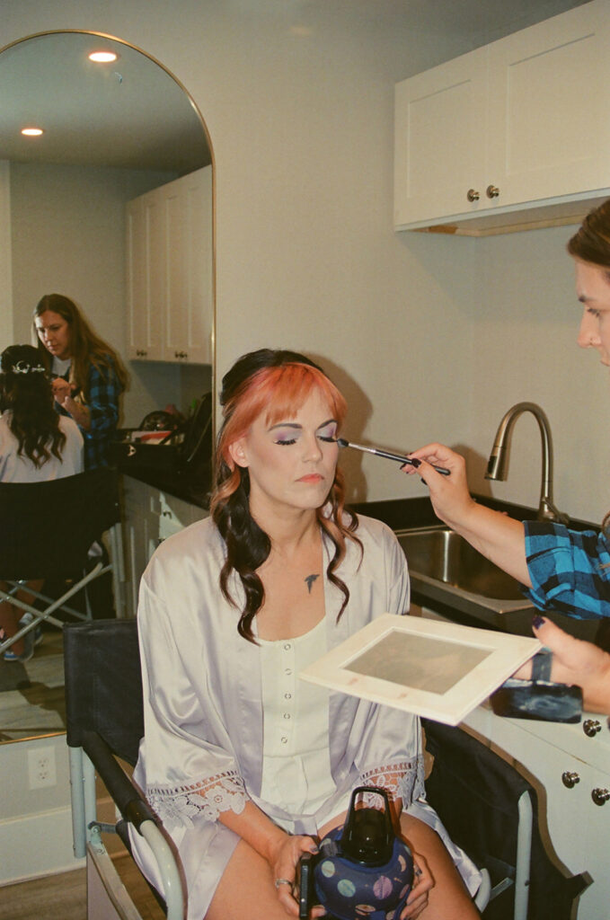 Bride getting makeup done on film before her Ferndale Michigan wedding.