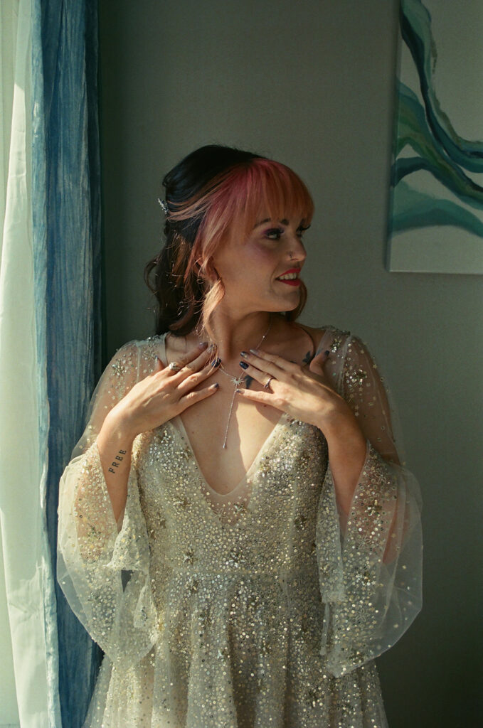 Bride wearing her celestial wedding dress and star necklace on film before her wedding.