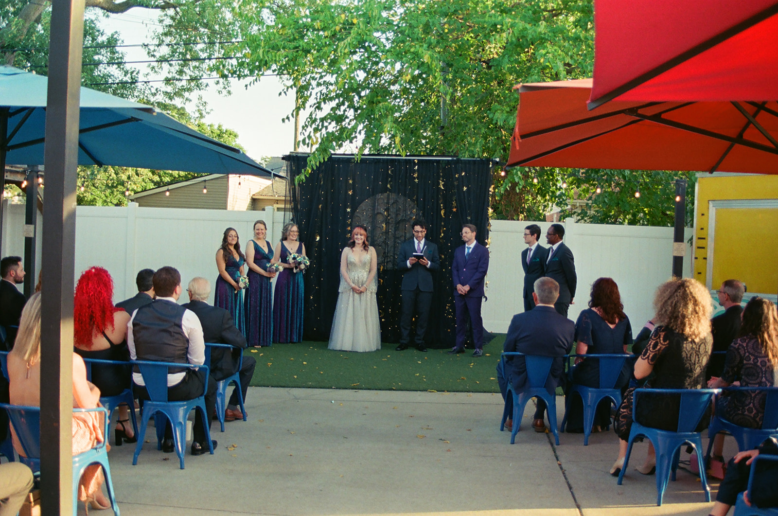 Bride and groom standing together during their outdoor Detroit Fleat wedding ceremony on film.