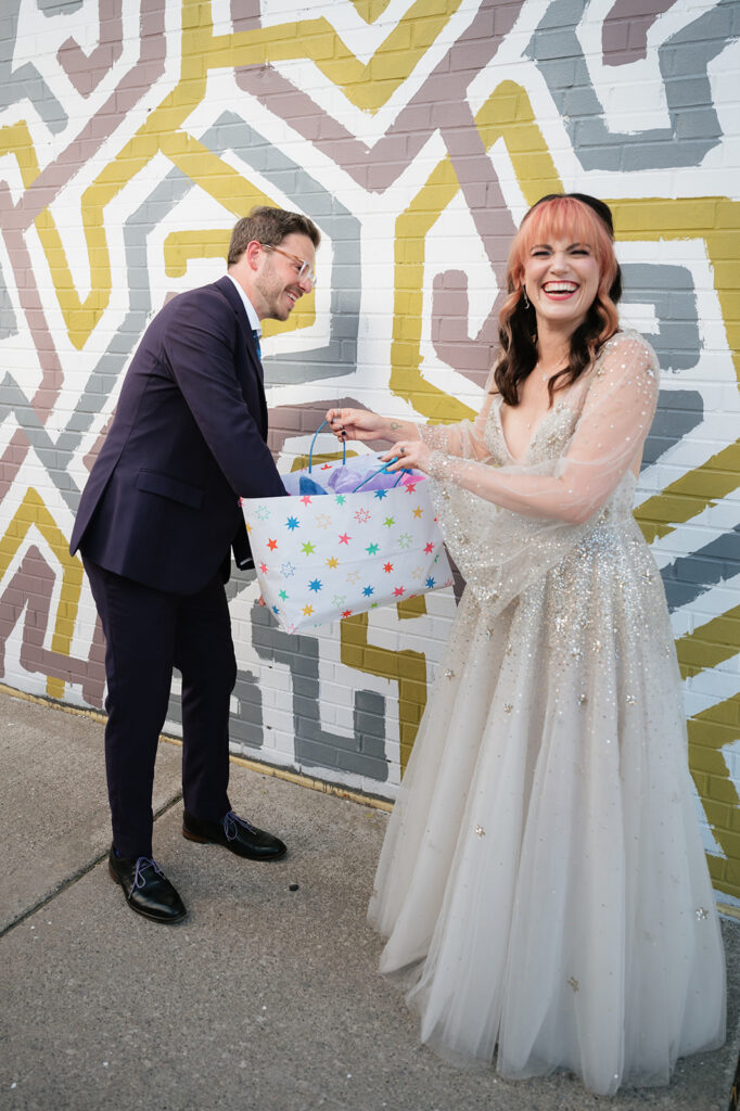 Groom opening his gift from the bride.