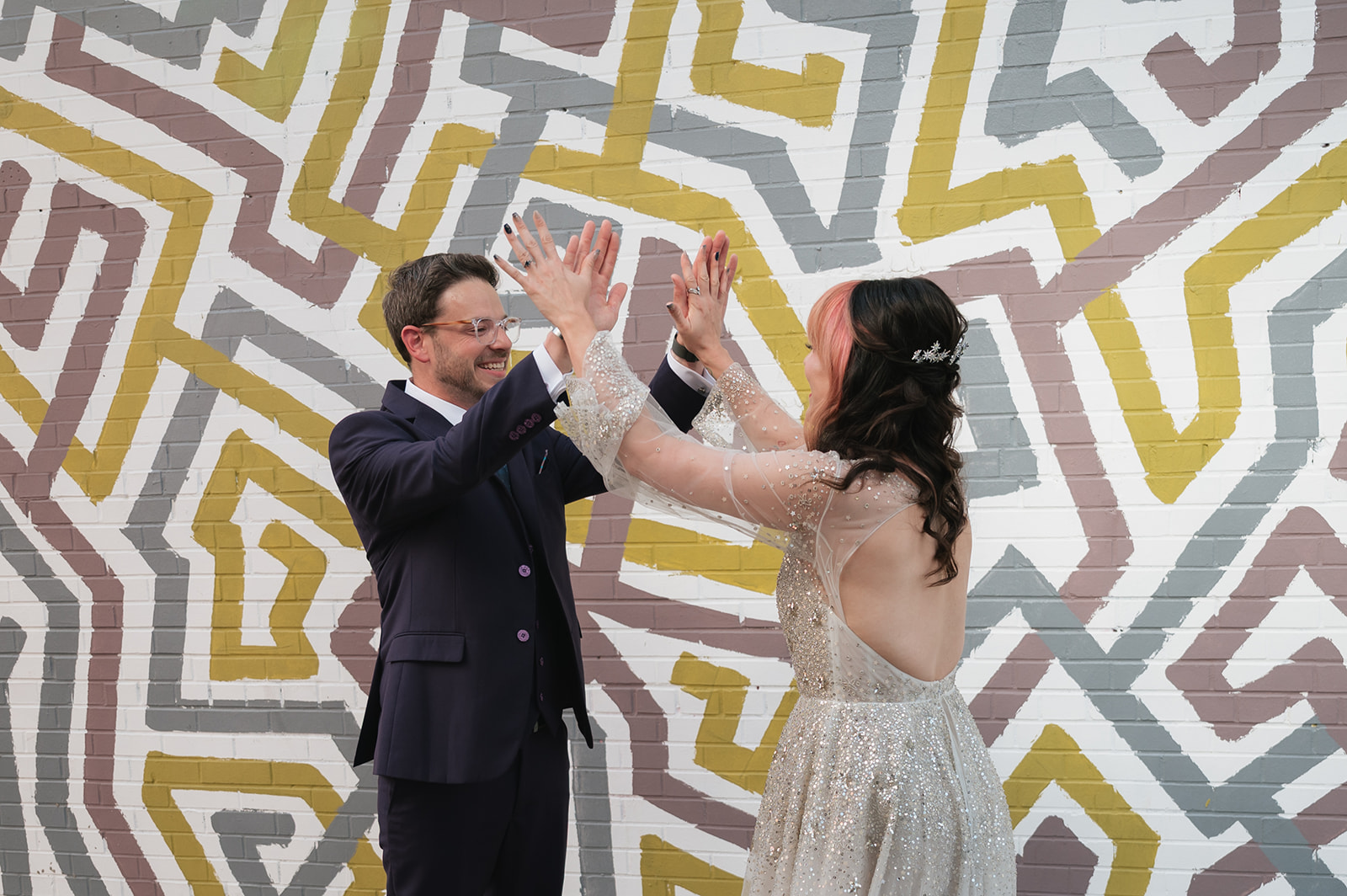 Bride and groom sharing a double high five during their Ferndale Michigan wedding first look.