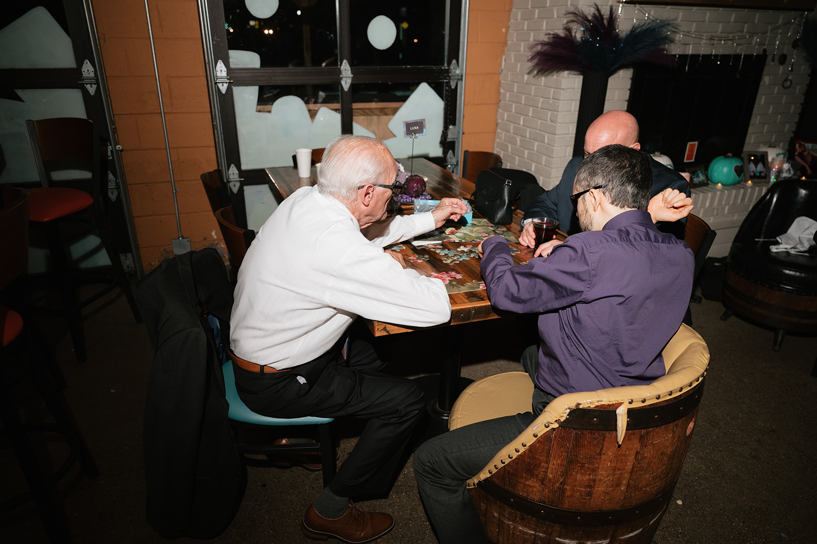 Family playing puzzles during a Detroit Fleat wedding reception.