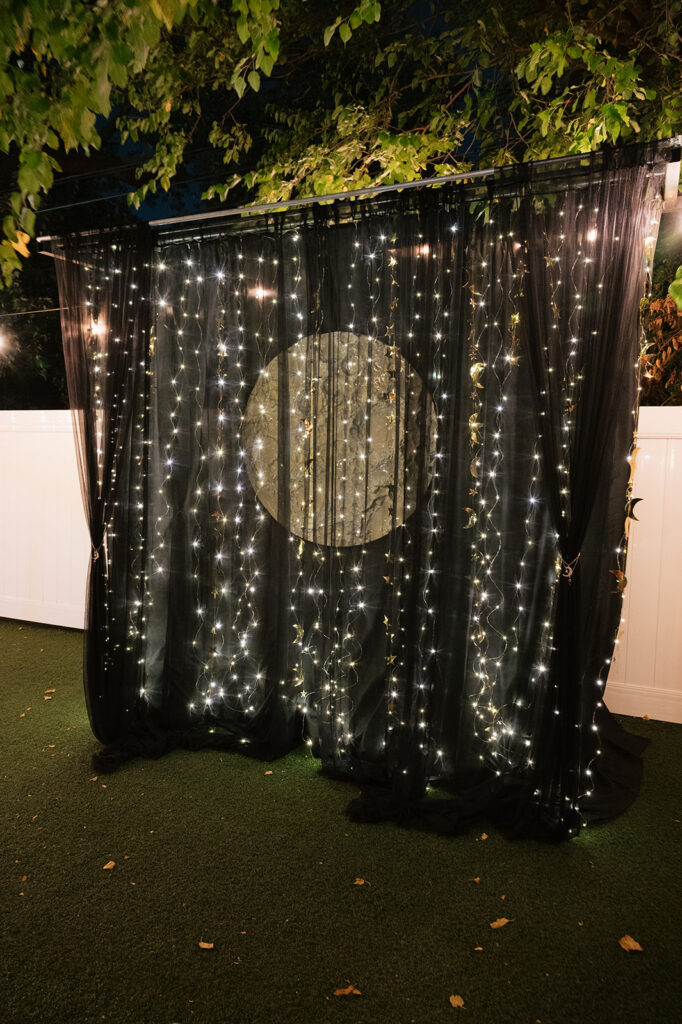 Moon wedding backdrop lit up at night at Detroit Fleat.