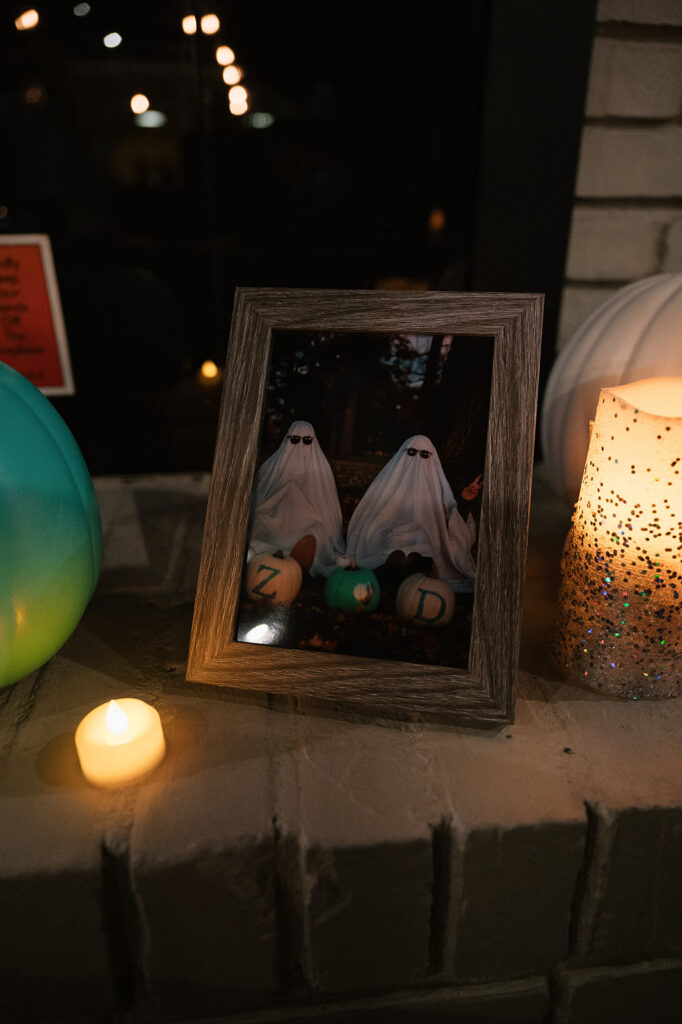 Bride and groom posing as ghosts in a photo frame.
