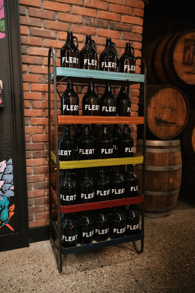 Detroit Fleat growlers displayed on colorful shelves during a wedding reception.