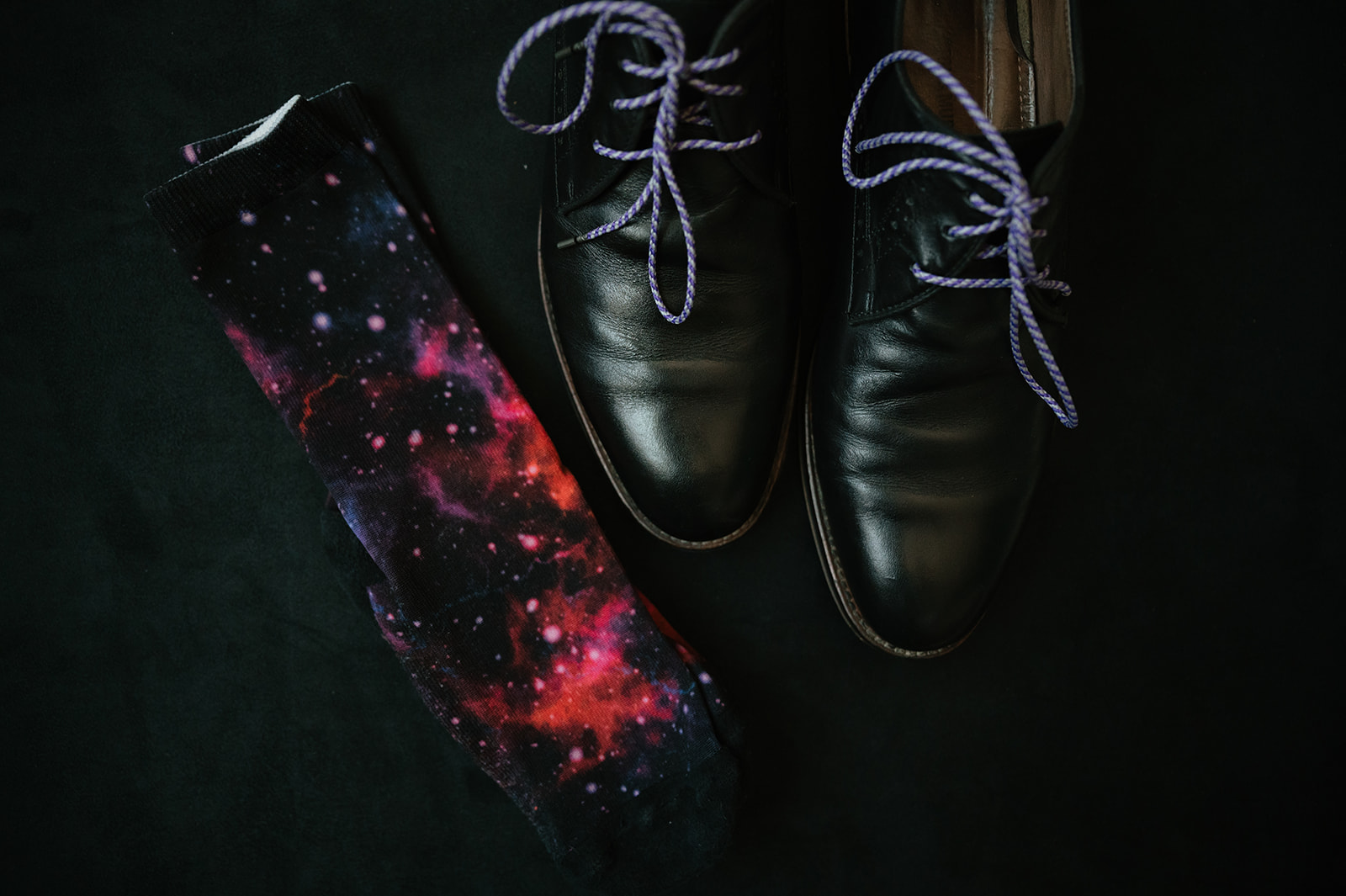 Groom details with galaxy socks and black wedding shoes for a Ferndale Michigan wedding.