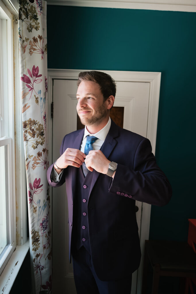 Groom’s purple suit with a galaxy-inspired tie for a Ferndale Michigan wedding.