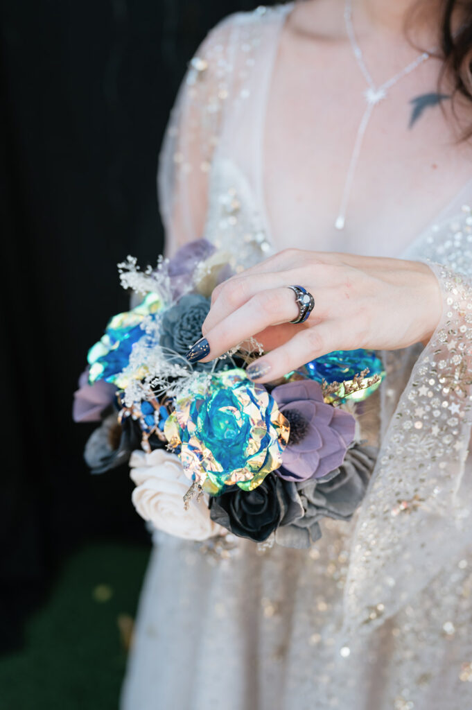 Bride holding a Sola Wood Flower bouquet during her space-themed Ferndale Michigan wedding.