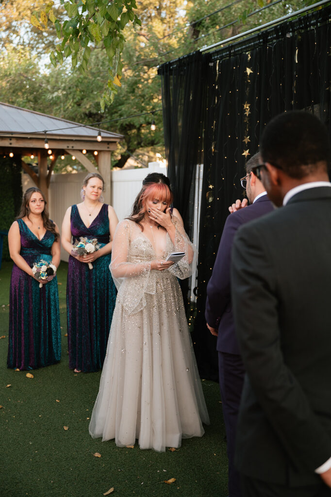 Bride getting emotional during vows at her space-themed Ferndale Michigan wedding.