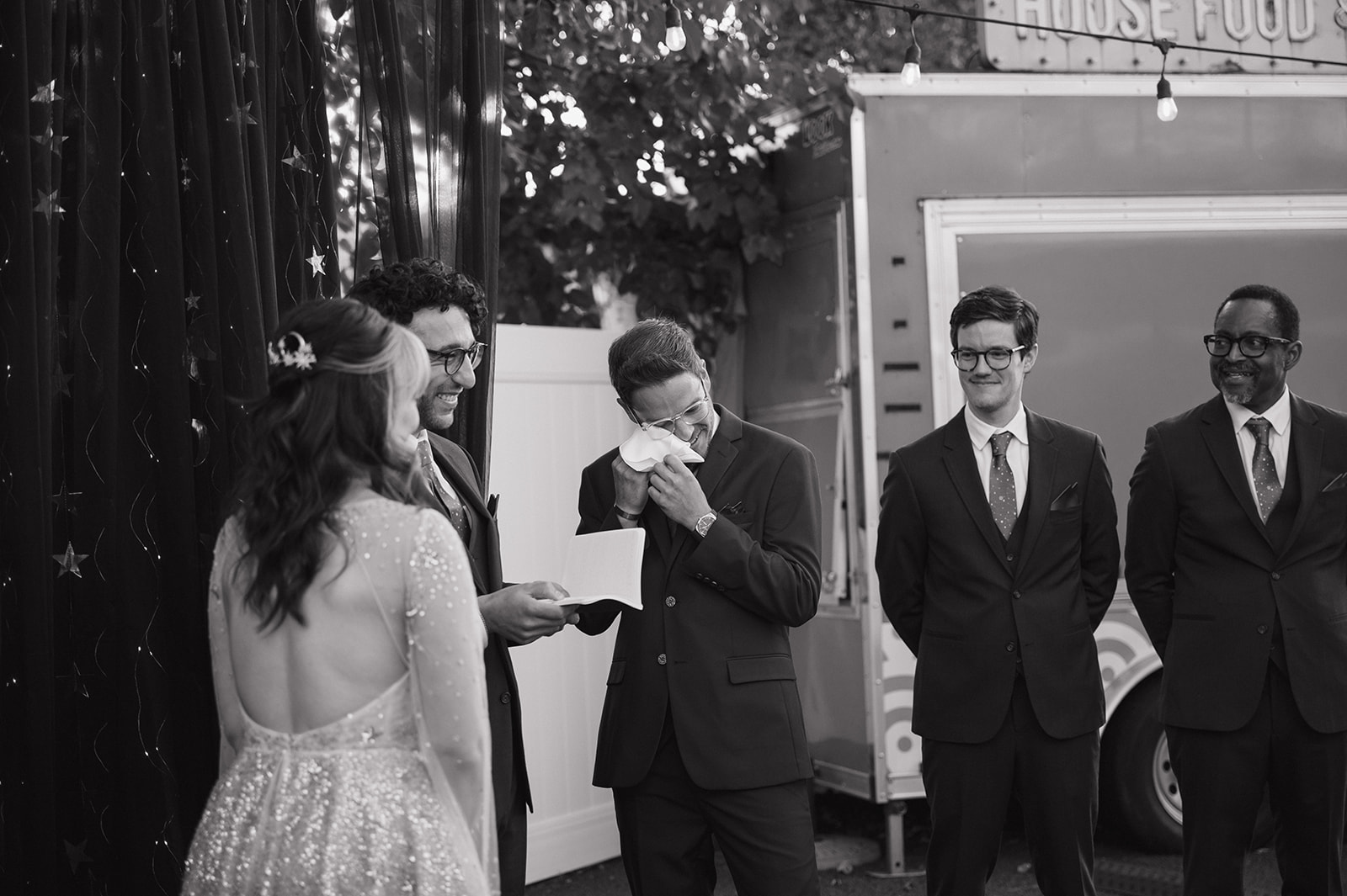 Groom wiping away tears during an emotional Ferndale Michigan wedding ceremony.