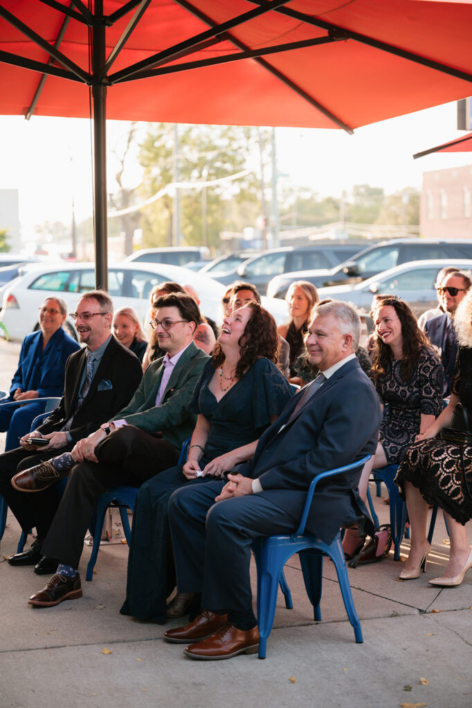 Wedding guests watching an outdoor ceremony at Detroit Fleat in Ferndale, Michigan.
