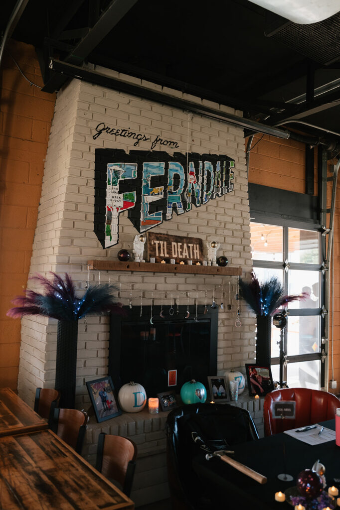 Detroit Fleat fireplace decorated with space-themed wedding details and a til death sign.