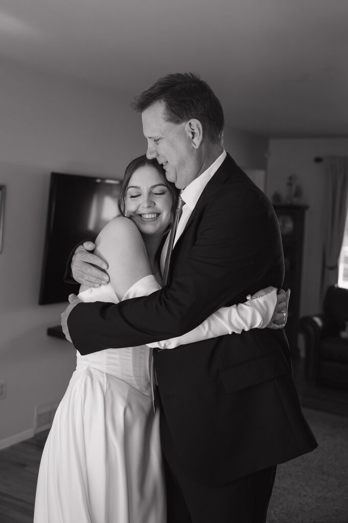 Bride hugging her dad before her Catholic wedding ceremony in Livonia Michigan.