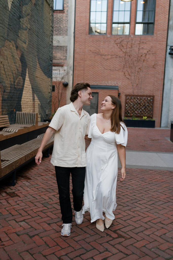 Couple walking together in The Belt during their downtown Detroit engagement photos.