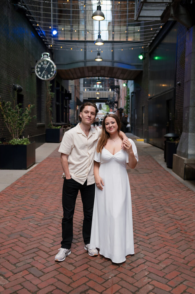 Couple posing together in The Belt for their downtown Detroit engagement session.