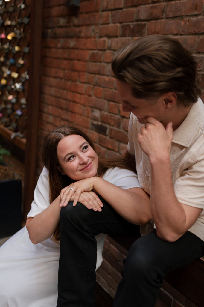 Couple sitting together near a bench in The Belt in downtown Detroit.