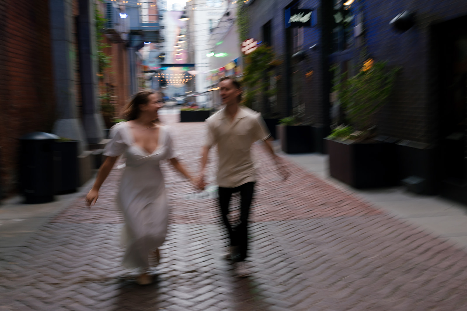 Motion bluer photo of a couple running in The Belt in downtown Detroit.