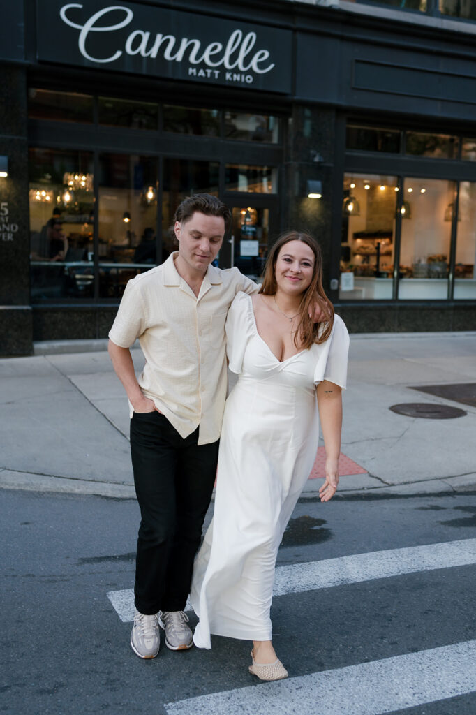 Couple walking through a downtown Detroit crosswalk during their engagement session.