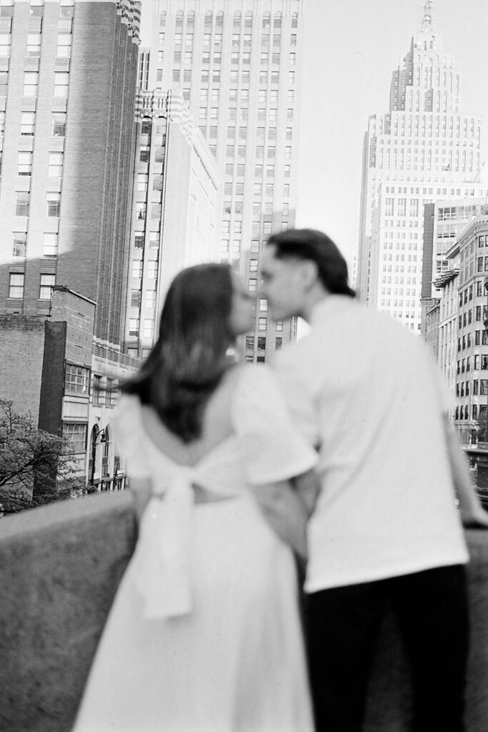 35mm film photo of a couple kissing in a rooftop in downtown Detroit.