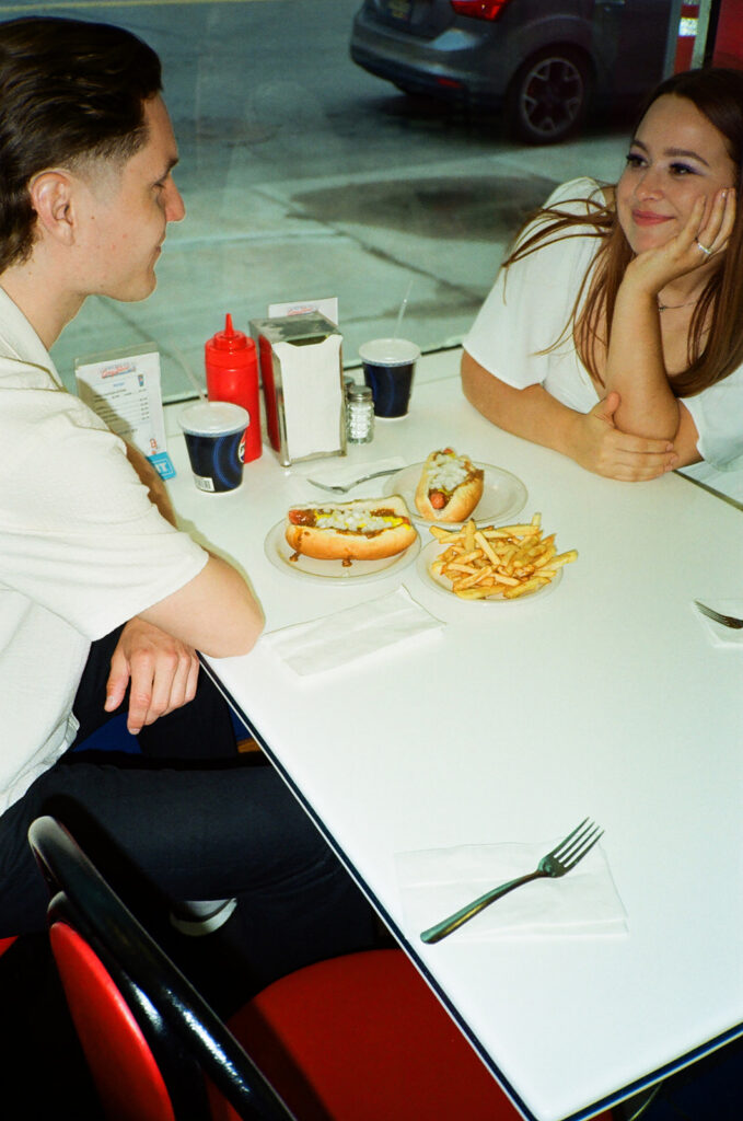 35mm film photo of a couple sitting inside American Coney Dog in Detroit, MI.