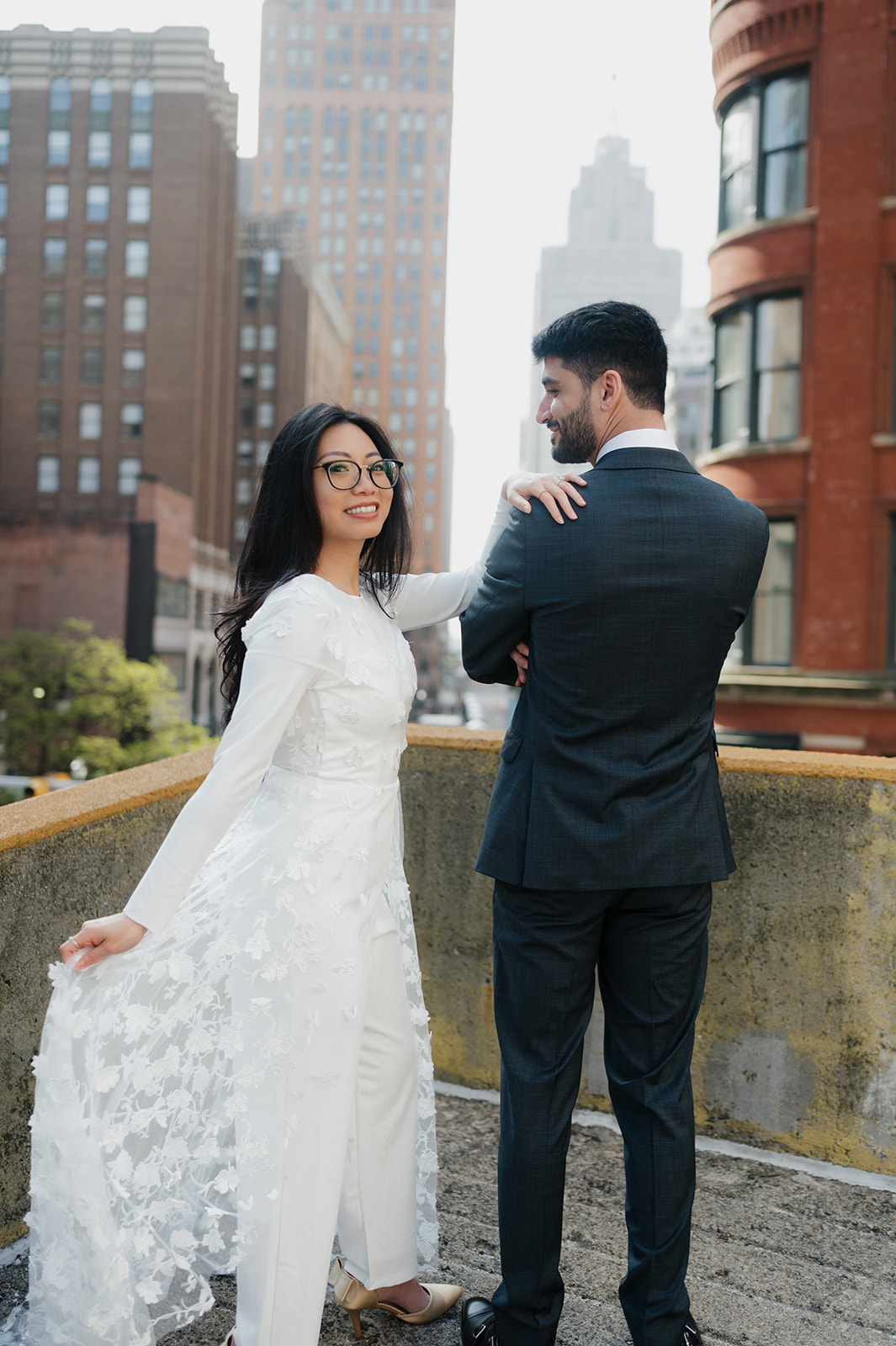Bride and groom posing in a rooftop for their downtown Detroit elopement photos.