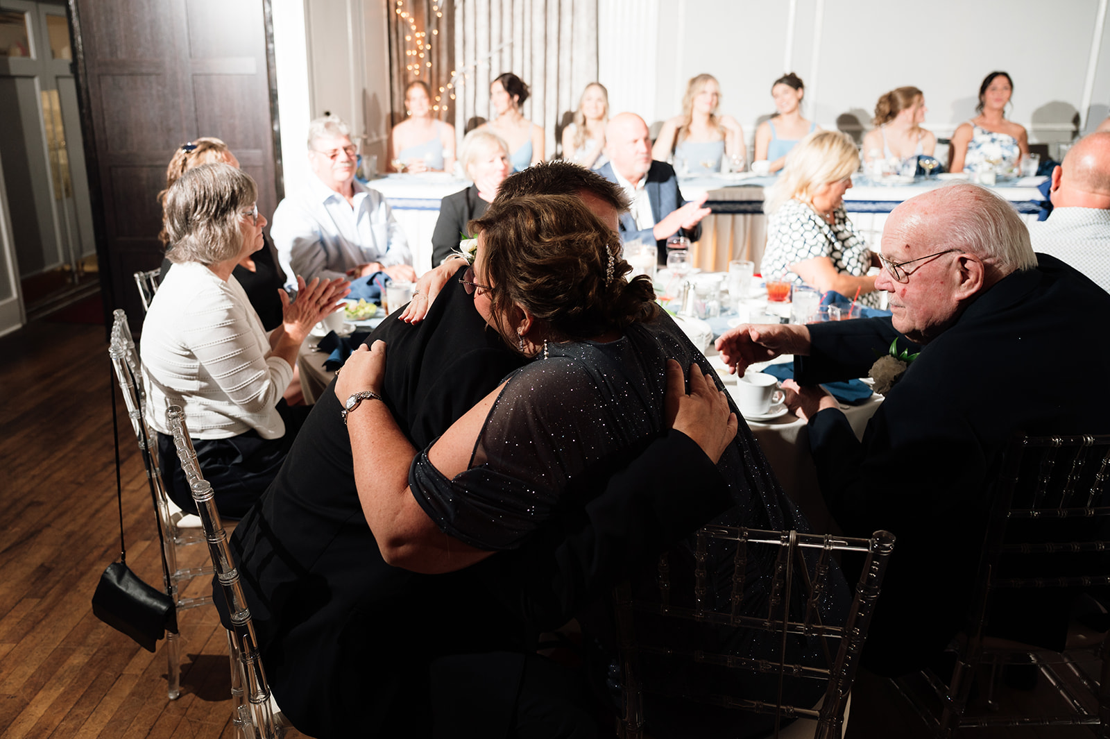 Brides mother and father hugging after speeches.