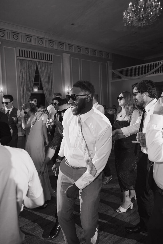 Flash photo of guests dancing during a Metro Detroit wedding reception at Meeting House Grand Ballroom in Plymouth.