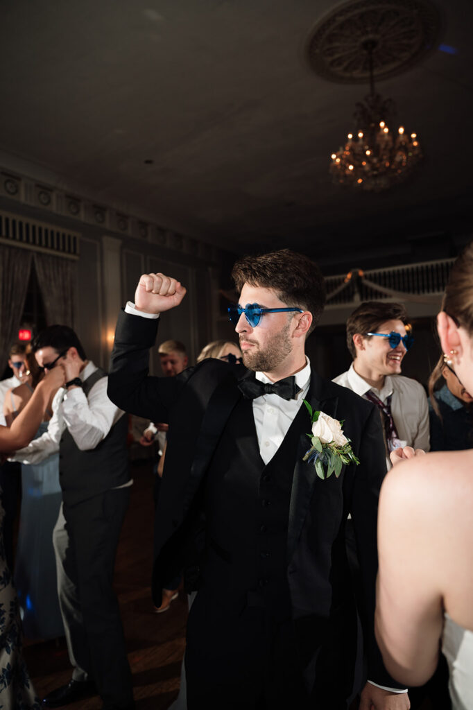 Flash photo of the groom dancing during the reception.